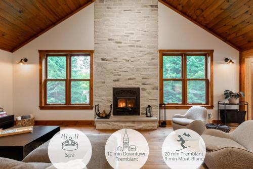 a living room with a fireplace and a stone wall at Chalet La Canopée -familial par excellence MontBlanc in Mont-Blanc