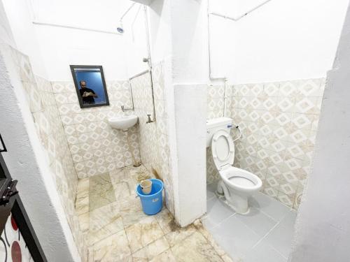 a small bathroom with a toilet and a sink at Radha Krishna Holiday Home in Puri