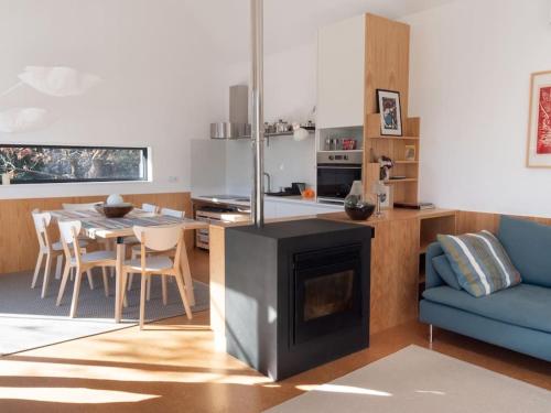 a kitchen and living room with a fireplace and a table at GoToGeres - Casa da Cortiça - Sobrenatura in Arcos de Valdevez