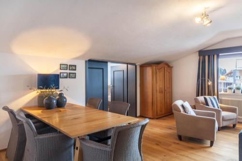 a dining room with a wooden table and chairs at Haus Excelsior Top 37b in Seefeld in Tirol