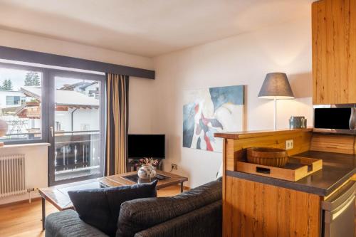 a living room with a couch and a table at Haus Excelsior Top 37b in Seefeld in Tirol