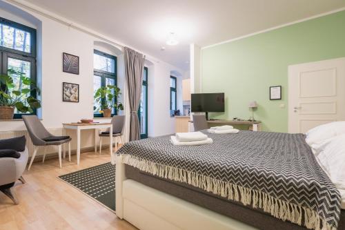 ein Schlafzimmer mit Bett und ein Wohnzimmer in der Unterkunft GREENs - ruhige schöne 1RWhg gut gelegen mit Balkon in Dresden