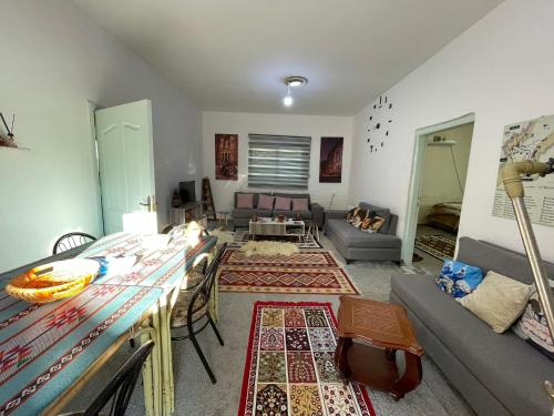 a living room with a couch and a table at Its your choice hostel in Wadi Musa