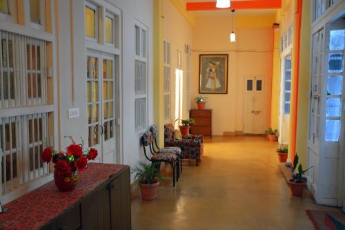 a hallway of a building with chairs and a table at Solan Retreat in Solan
