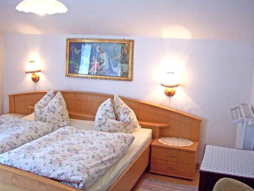 a bedroom with two beds and a picture on the wall at Ferienwohnung Haus Jennerwein in Sachrang