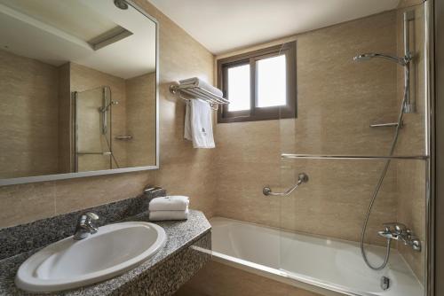 a bathroom with a sink and a shower at Atlantica Oasis Hotel in Limassol