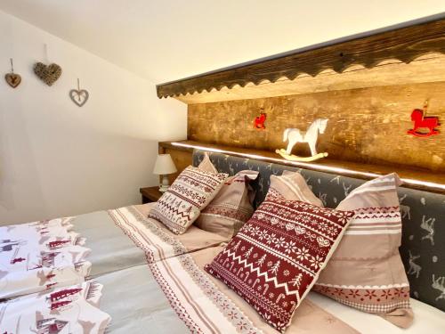 a bedroom with a bed with pillows on it at Grieshof am Pühel in Valle Di Casies