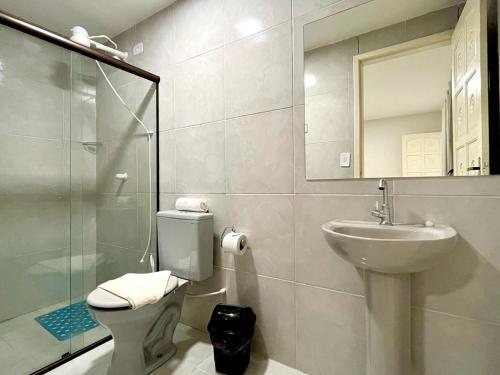 a bathroom with a toilet and a sink and a shower at Casa em Porto de Galinhas by AFT in Porto De Galinhas