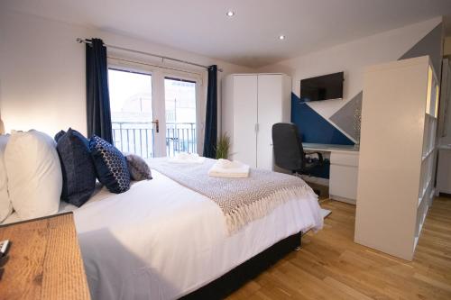 een slaapkamer met een bed, een bureau en een raam bij Union Suite in Cambridge