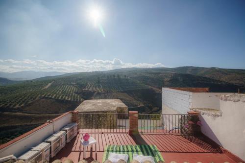 a balcony of a house with a view of a valley at Casa singular y con encanto in Baena