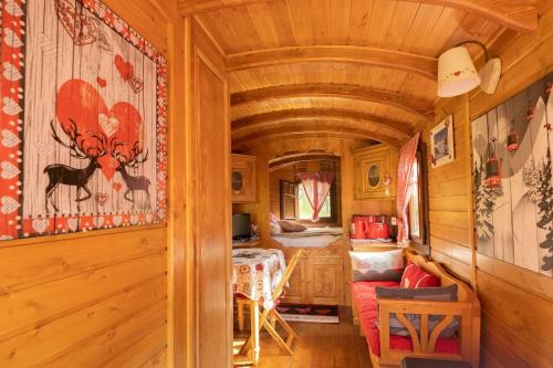 a tiny house with a bedroom and a living room at Roulotte Ancolie in Gèdre