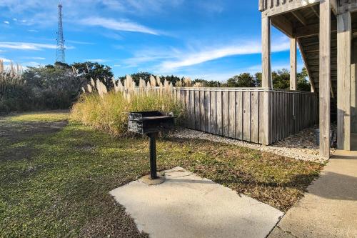 a mailbox sitting in a yard next to a fence at Out of the Blue 574 in Rodanthe