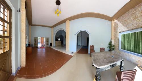 a living room with a table and a brick wall at Family’s gardem 