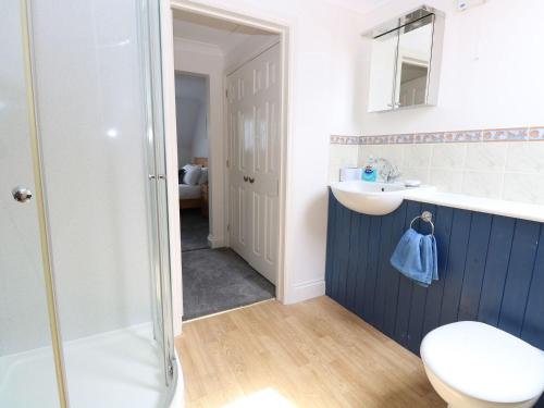 a bathroom with a shower and a sink and a toilet at Drifters in Great Yarmouth