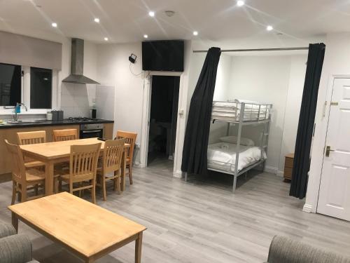 a room with a kitchen and a table and a bunk bed at Spacious Entire Two Double Bedrooms Flat, N 3 in Great Yarmouth