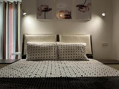 a bedroom with a bed with two pillows on it at Sliema, Apt7, Stylish 2 Bedroom Apartment with Parking in Sliema