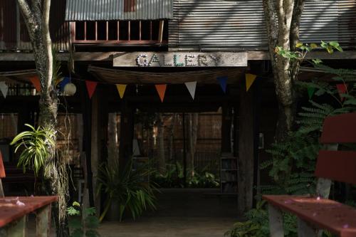 a patio with a table and flags on it at Art House at Chiangdao - Moon House in Chiang Dao