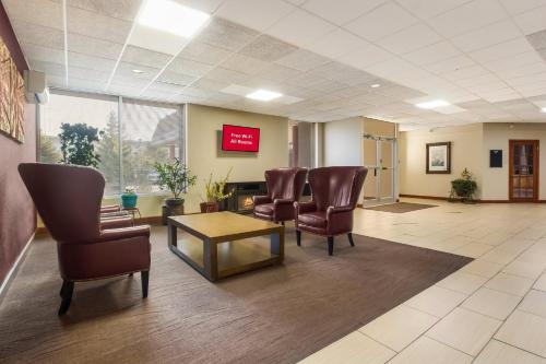 a waiting room at a hospital with chairs and a table at Red Roof Winchester - Lexington East in Winchester