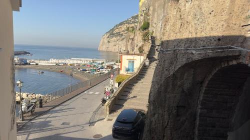 a car is parked on a road next to a mountain at Hotel Giosue' a mare Sorrento in Meta