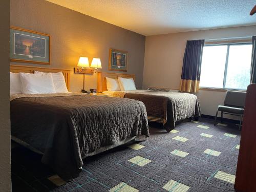 a hotel room with two beds and a window at Walker Hotel in Walker