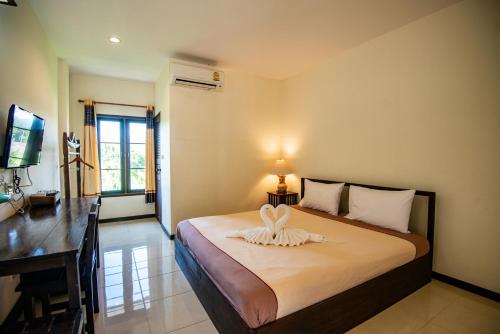 a bedroom with a bed with a heart on it at Rimtarn Resort in Mae Hong Son