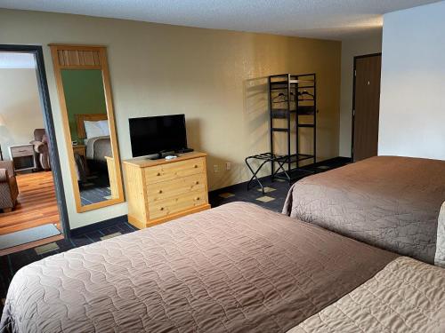a hotel room with two beds and a television at Walker Hotel in Walker