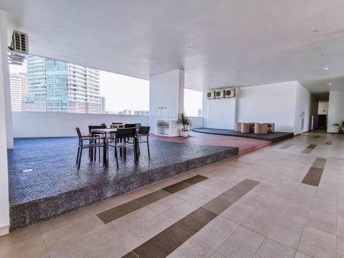 a dining area with tables and chairs in a building at 3R2B Near Titiwangsa Station PWTC HKL KLCC IJM TRA115 in Kuala Lumpur