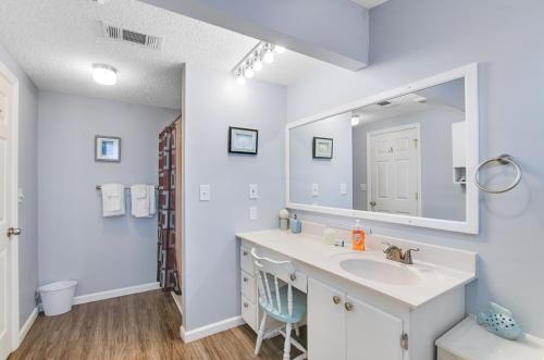 a bathroom with a sink and a mirror at Tybee Southern Comfort in Tybee Island