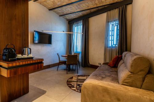 a living room with a couch and a table at Gasometer Urban Suites in Rome