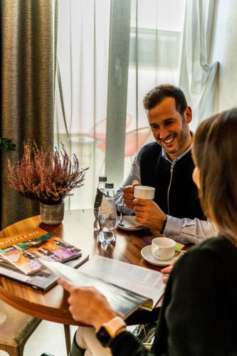 a group of people sitting around a table at Gasometer Urban Suites in Rome