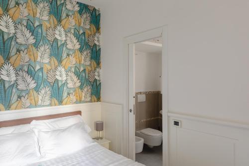 ローマにあるルレ ローマ セントロの花の壁紙を用いたベッドルーム1室(ベッド1台付)