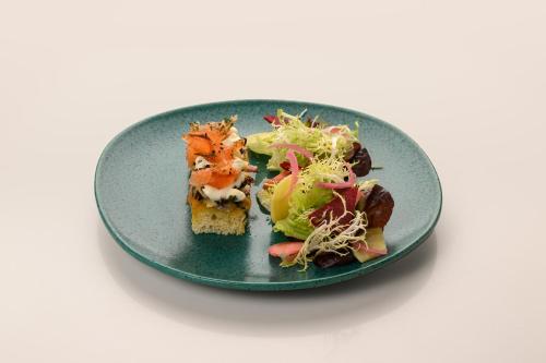 a plate of food with a salad on it at Inspira Liberdade Boutique Hotel in Lisbon