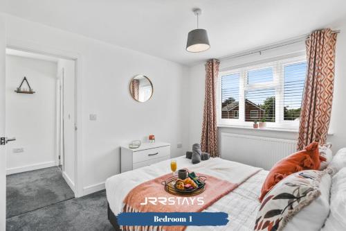 a bedroom with a bed with a bowl of fruit on it at Wolverhampton - Amazing 3 Bedroom, Sleeps 6, Wi-Fi - JRR Stays in Fallings Park