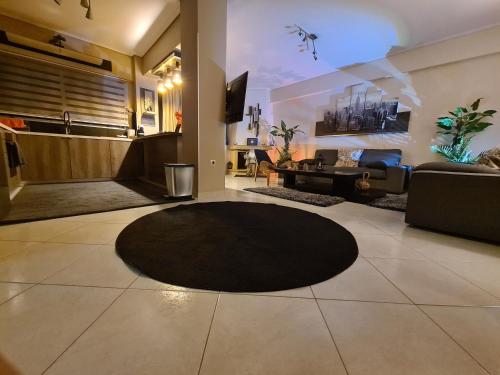 a living room with a black rug on the floor at Luxury Home in Spáta