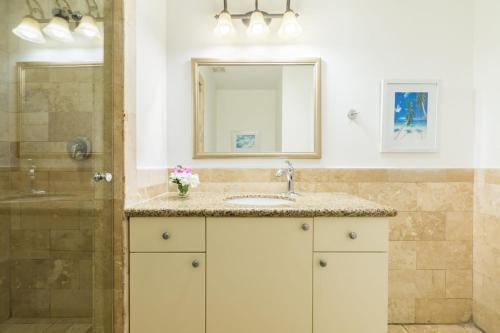 a bathroom with a sink and a shower at New Listing La Vista Azul Spacious 1 Bedroom Condo in Turtle Cove