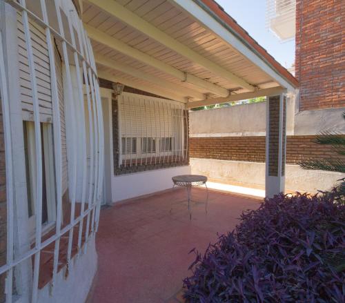 a patio with a table and awning on a building at Residencia Morón in Morón