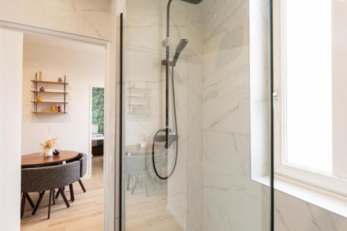a shower with a glass door in a bathroom at DIFY Paul Bert - Part-dieu in Lyon