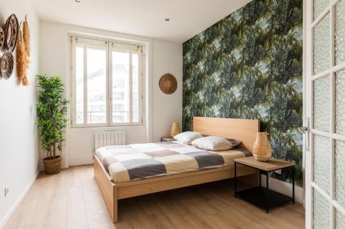 a bedroom with a bed and a wall mural at DIFY Paul Bert - Part-dieu in Lyon