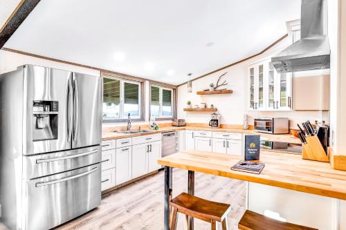a kitchen with white cabinets and a stainless steel refrigerator at Hi View House in Joshua Tree