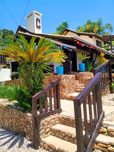 a house with a gate and stairs in front of it at Pousada Caminho do Mar in Bombinhas