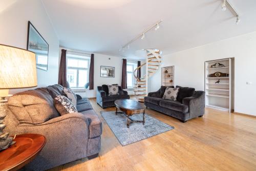 a living room with two couches and a table at Old Town - Vana Viru Apartment in Tallinn