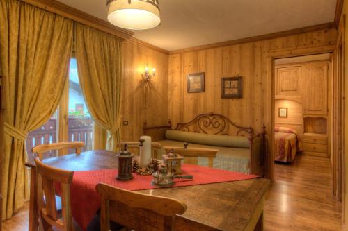 a bedroom with a table and a bed in a room at B&B Residence Checrouit in Courmayeur