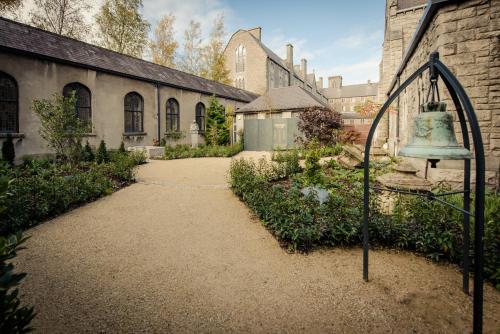 an old bell in a courtyard of a building at DCU Rooms All Hallows in Dublin