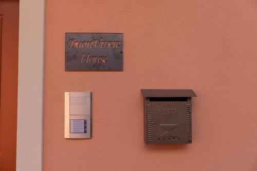 a sign on the side of a wall with a bird trap thing at BuonVivere House in Verduno