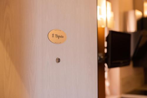 a door with a sign that reads it up at BuonVivere House in Verduno