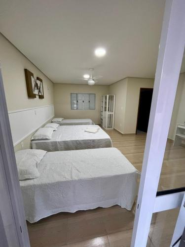 two beds in a room with two beds sidx sidx sidx at Pousada Saint James in Águas de Lindóia