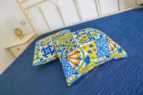 a bed with a pillow on top of it at Cà del Re Holiday in Partinico