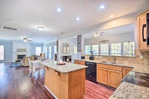 a kitchen and living room with a counter top at Chic Gastonia Home with Deck, Fire Pit and Grill! in Gastonia