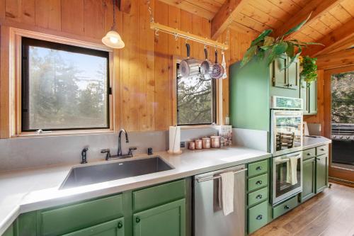 a kitchen with green cabinets and a sink at Tahquitz Rock Lodge in Idyllwild