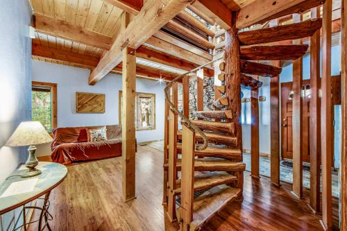 a spiral staircase in a living room with wooden ceilings at Tahquitz Rock Lodge in Idyllwild